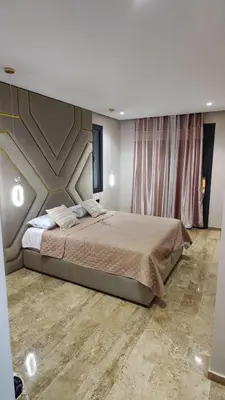 a bedroom with a large bed in a room at Appartement de prestige à Dar bouazza avec plusieurs piscines et à proximité à la plage in Tamaris