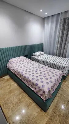 a bedroom with two beds in a room at Appartement de prestige à Dar bouazza avec plusieurs piscines et à proximité à la plage in Tamaris