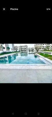 a picture of a swimming pool in a building at Appartement de prestige à Dar bouazza avec plusieurs piscines et à proximité à la plage in Tamaris