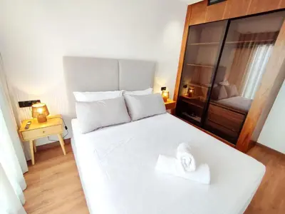 a white bed with a white towel on top of it at Studio Confortable et Cozy 5 min du stade CAN2025- Maarif Casablanca in Casablanca