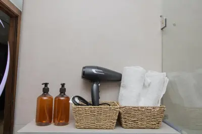 a bathroom counter with towels and a hair dryer and a blow drier at Studio Confortable et Cozy 5 min du stade CAN2025- Maarif Casablanca in Casablanca