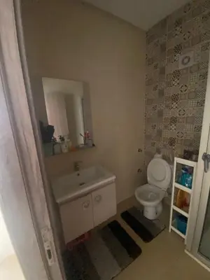 a bathroom with a sink and a toilet at Beach apartment in Bouznika