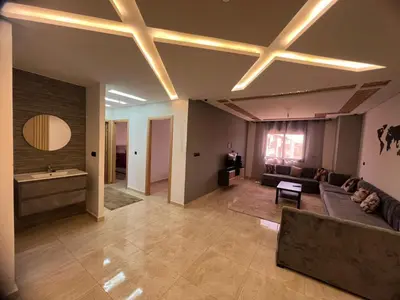 a living room with a couch and a table at 322 Costa beach , Bouznika in Bouznika