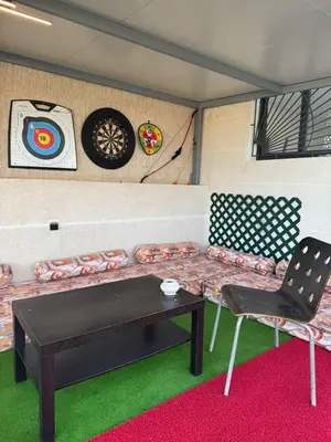 a room with a couch and a table and chairs at 322 Costa beach , Bouznika in Bouznika