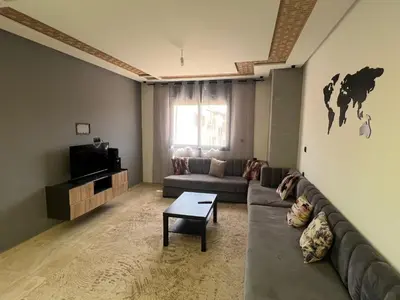 a living room with a couch and a tv at 322 Costa beach , Bouznika in Bouznika