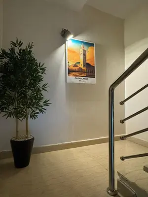 a hallway with a potted plant and a picture on the wall at 322 Costa beach , Bouznika in Bouznika