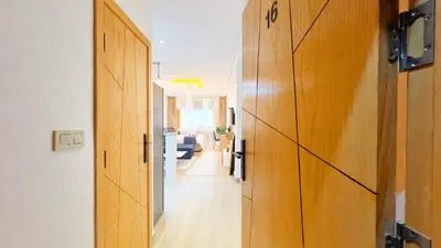a hallway with a door leading to a living room at Cosy studio Steps to Shore and Tramway in Rabat