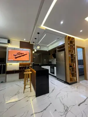 a large kitchen with a large tv on the wall at Cozy studio in Bouznika