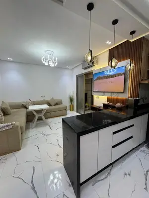 a living room with a couch and a tv at Cozy studio in Bouznika
