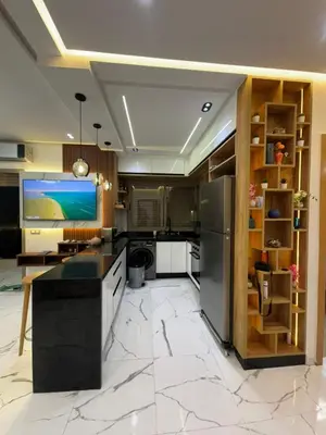 a large kitchen with a large white marble floor at Cozy studio in Bouznika