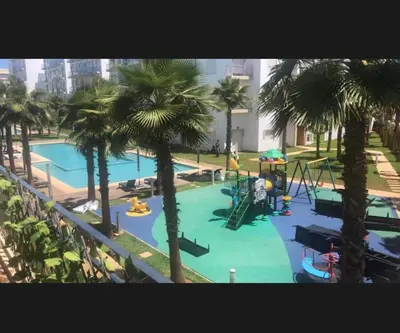 an overhead view of a swimming pool with palm trees at Luxe appartement in Bouznika