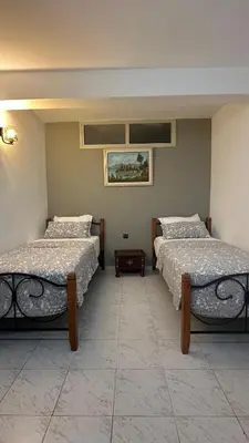 two beds sitting in a room with at Dar Alyakoute - Harhoura in Temara