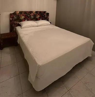 a large bed in a bedroom with a white bedspread at Dar Alyakoute - Harhoura in Temara