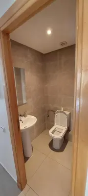 a bathroom with a toilet and a sink at Appartement lux a mansoria les terrasses 2 et 3 in Mansouria