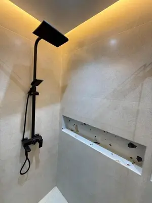 a lamp on the corner of a bathroom with a wall at New apartment in the heart of Rabat in Rabat