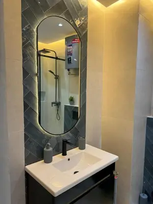 a bathroom with a sink and a mirror at New apartment in the heart of Rabat in Rabat
