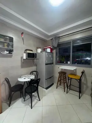 a kitchen with chairs and a table and a refrigerator at Residence sables dor Mohammedia in Mohammedia