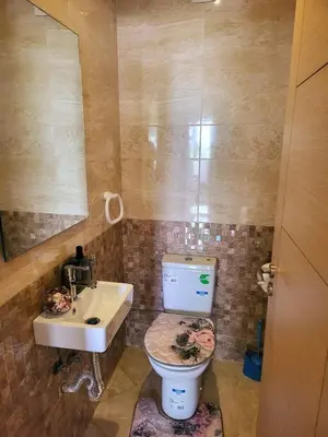 a bathroom with a toilet and a sink at Bouznika Apartement de luxe 2 Chambres RDC in Bouznika