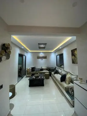 a large living room with a couch and a table at Blanca beach in Sidi Rahal