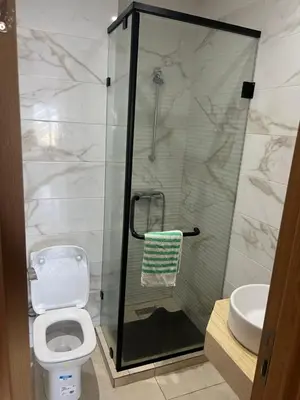 a bathroom with a shower and a toilet and a sink at La perle de Sidi by Rachid in Dar Oulad Hajj Kassem