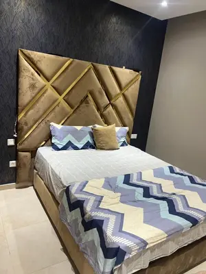 a bedroom with a large bed with a large headboard at La perle de Sidi by Rachid in Dar Oulad Hajj Kassem