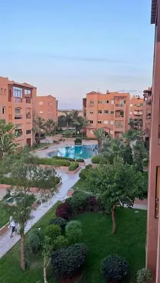a view of a courtyard with a pool in a city at Appartement a louer a mansouria rico flores in O Ben Slimane