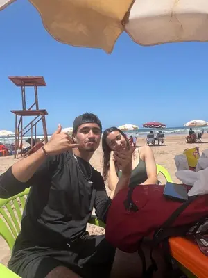 a man and a woman sitting on the beach at Résidence sara in Casablanca