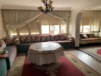 a living room with a couch and a table at Résidence sara in Casablanca