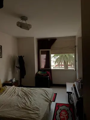 a bedroom with a bed and a window at Résidence sara in Casablanca