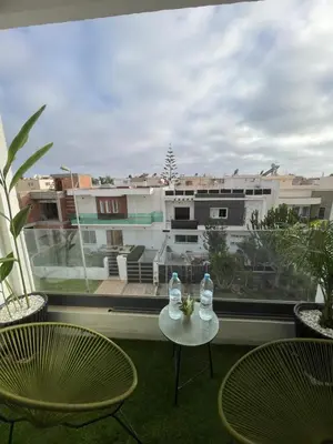 two bottles of water sitting on a table on a balcony at Luxueux appartement a harhoura près de la mer in Temara