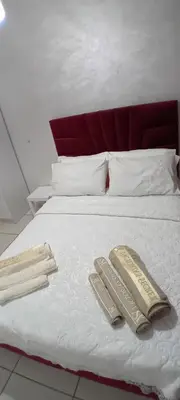 a bed with two pillows and two towels on it at Modern and comfortable apartment in mohammedia in Ben Yakhlef