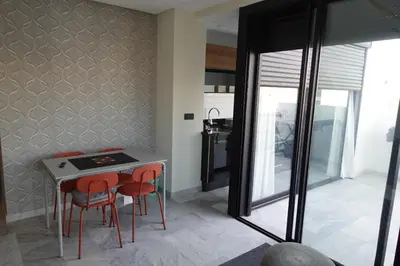 a kitchen with a table and two red chairs at Calm and lovely appartement well located in Casablanca