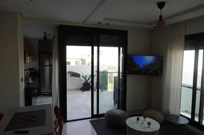 a living room with a sliding glass door to a patio at Calm and lovely appartement well located in Casablanca