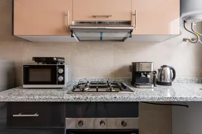 a kitchen with a stove and a microwave at TT Holidays Centro in Rabat