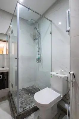 a bathroom with a toilet and a glass shower at TT Holidays Centro in Rabat