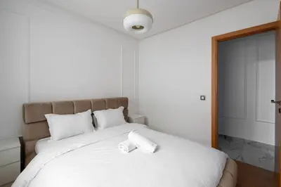 a bedroom with a large bed with a white pillow on it at TT Holidays Centro in Rabat