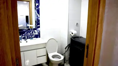 a bathroom with a toilet and a sink and a mirror at Beautiful and cosy apartment in Casablanca