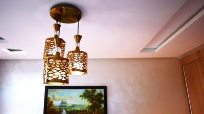 two lights hanging from the ceiling in a room at Beautiful and cosy apartment in Casablanca