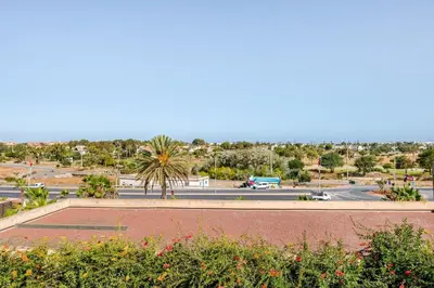 a view of a parking lot and a street at Grand Appartement de standing sécurisé, proche plage avec piscine privée in Bouznika
