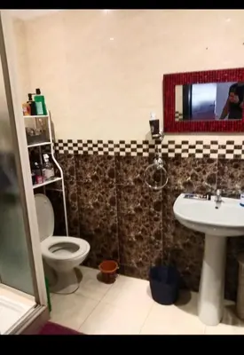 a bathroom with a toilet and a sink and a mirror at Casablanca in Bouznika