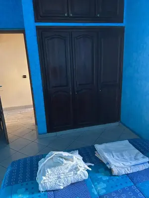 a blue room with a bed with two towels on it at Villa Chérine in Casablanca