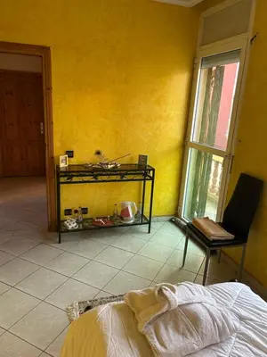 a yellow room with a bed and a window at Villa Chérine in Casablanca