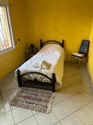 a bedroom with a bed with a dog laying on it at Villa Chérine in Casablanca