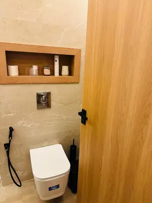 a bathroom with a toilet and a wooden door at Hidden Central Cozy Gem Ghandi Calm Fast WiFi Parking in Casablanca