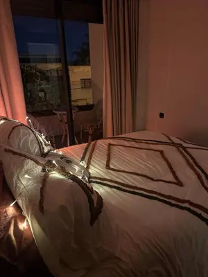 a bed in a room with a large window at Hidden Central Cozy Gem Ghandi Calm Fast WiFi Parking in Casablanca