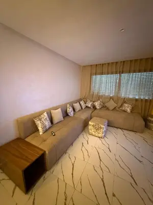 a living room with a large couch with pillows at Superbe Modern Studio Casa City Center in Casablanca