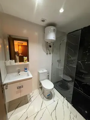 a bathroom with a toilet and a sink and a shower at Superbe Modern Studio Casa City Center in Casablanca