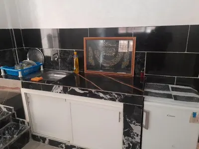 a kitchen with a sink and a picture on the counter at Apartment Surf in Skhirat