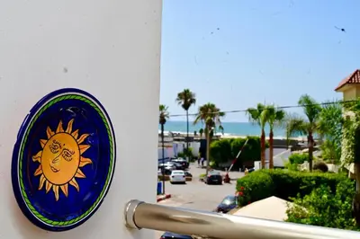 a plate on a wall with a sun on it at Appartement de Luxe - Piscine et Accès à la Plage in El Harhoura