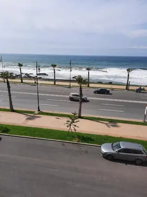 a car parked on the side of a road near the ocean at Rabat en face de océan in Rabat